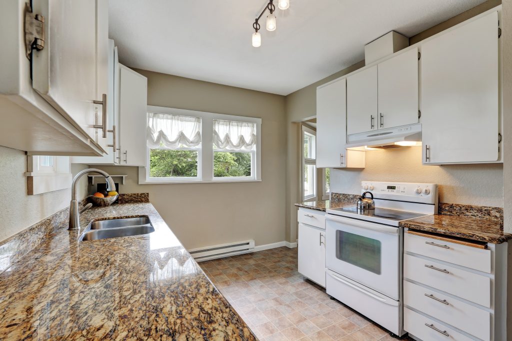 Simple white kitchen room with granite counters - McCart Handyman, Land O' Lakes FL